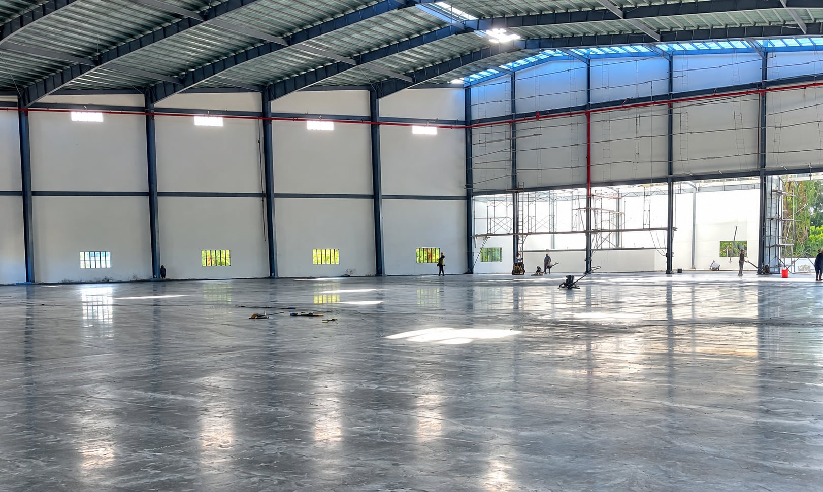 Newly finished concrete floor slab inside a large warehouse